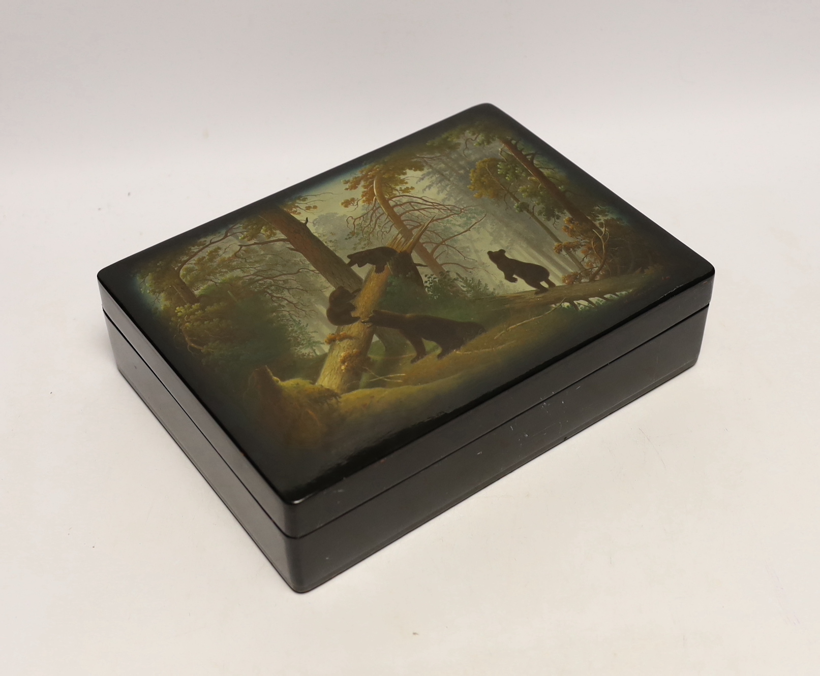 A Russian lacquer rectangular box, by Fedoskino, painted with the scene ‘Morning in the wood’ , based on the original painting by Shishkin, 25.5 cm wide, Please note this lot attracts an additional import tax of 5% on th